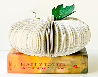 decorative pumpkin made of white book pages on top of Harry Potter and Deathly Hallows book
